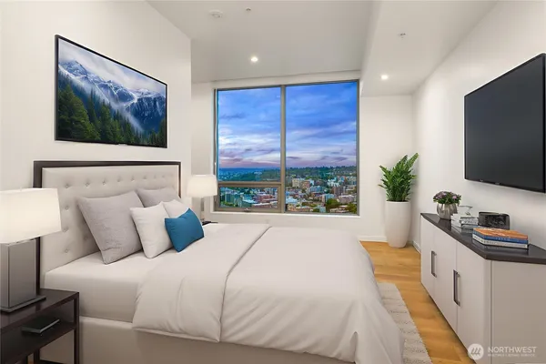 a bedroom with a large bed and a flat screen tv