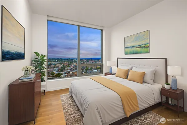 a bedroom with a large bed and a potted plant