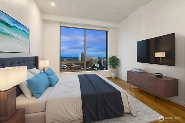 a bedroom with a bed and a flat screen tv