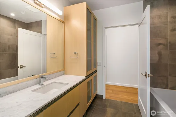 a bathroom with a granite countertop sink and a mirror