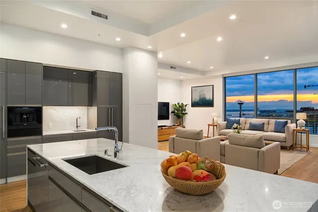 a large kitchen with a large window and stainless steel appliances
