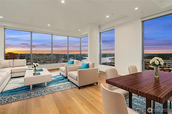 a living room with furniture and a floor to ceiling window