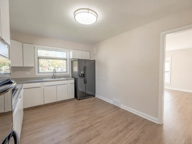 a kitchen with a refrigerator and window
