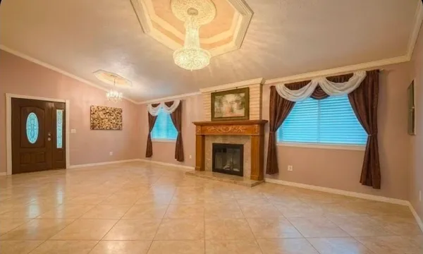 a view of a livingroom with wooden floor and a ceiling fan