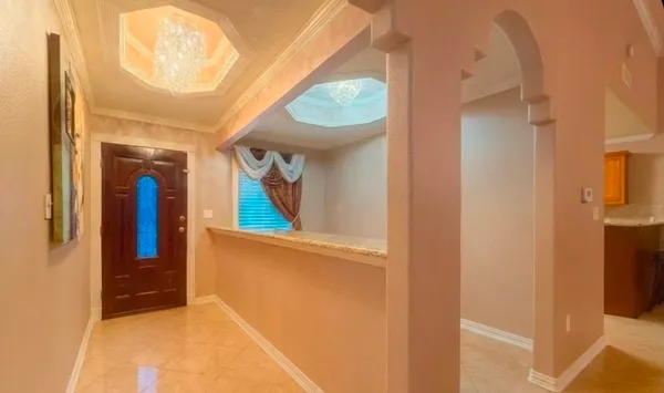 a view of entryway and hall with wooden floor