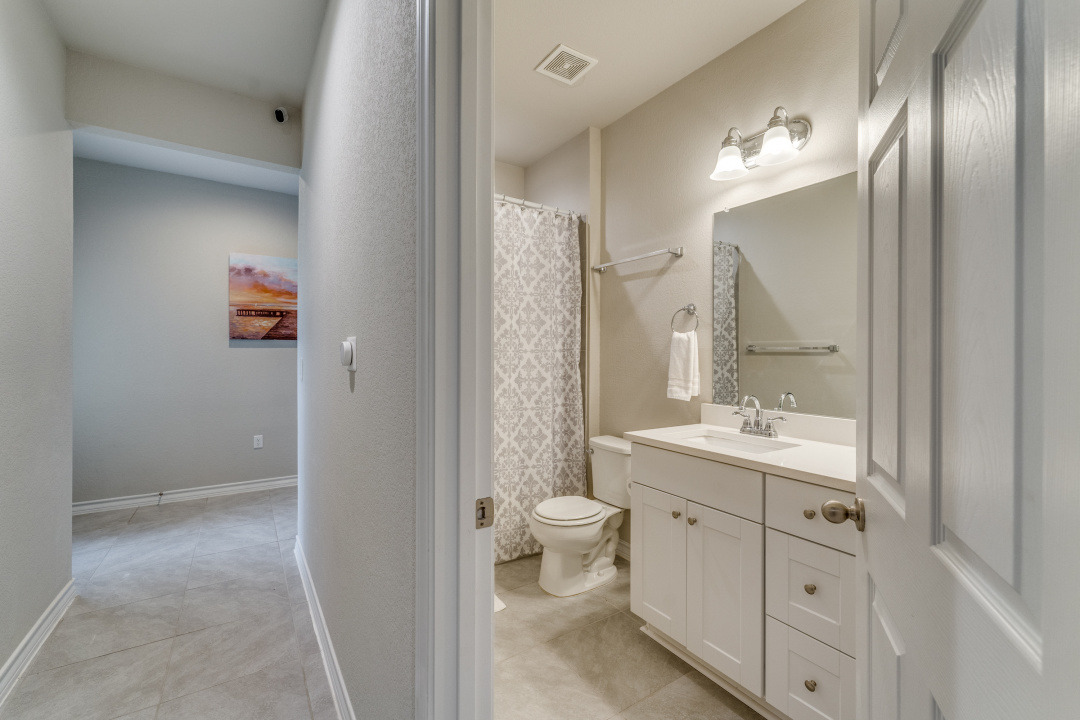 5921 Lehman Way Austin, TX 78747 - Photo 19 of 25 A well-appointed bathroom features a single vanity, a toilet, and a combination shower/tub, ready for daily routines.
