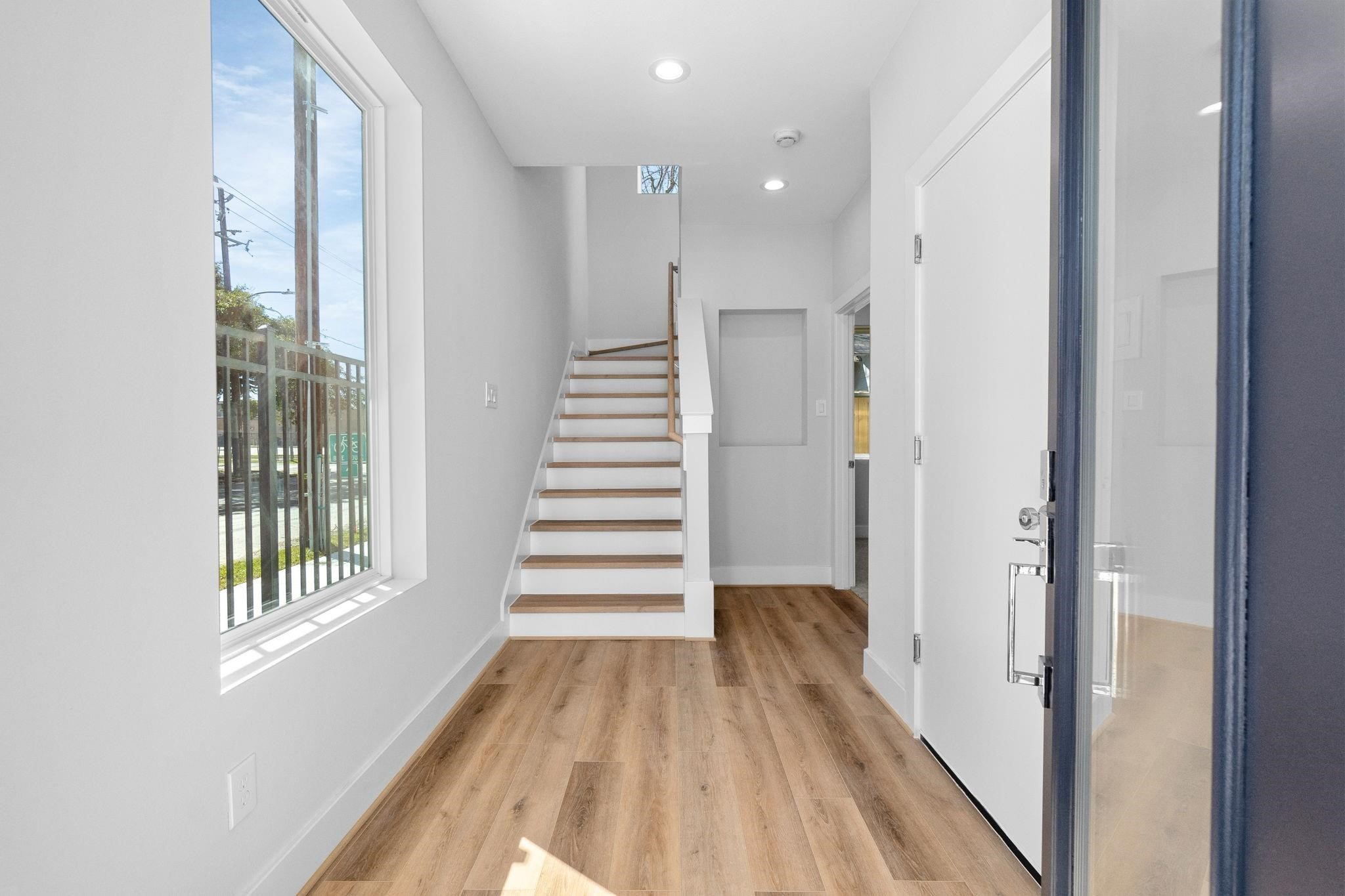 903 Quitman Street, Unit B Houston, TX 77009 - Photo 20 of 23 Contemporary staircase with wood treads and clean railing design, complemented by high ceilings and abundant natural light.