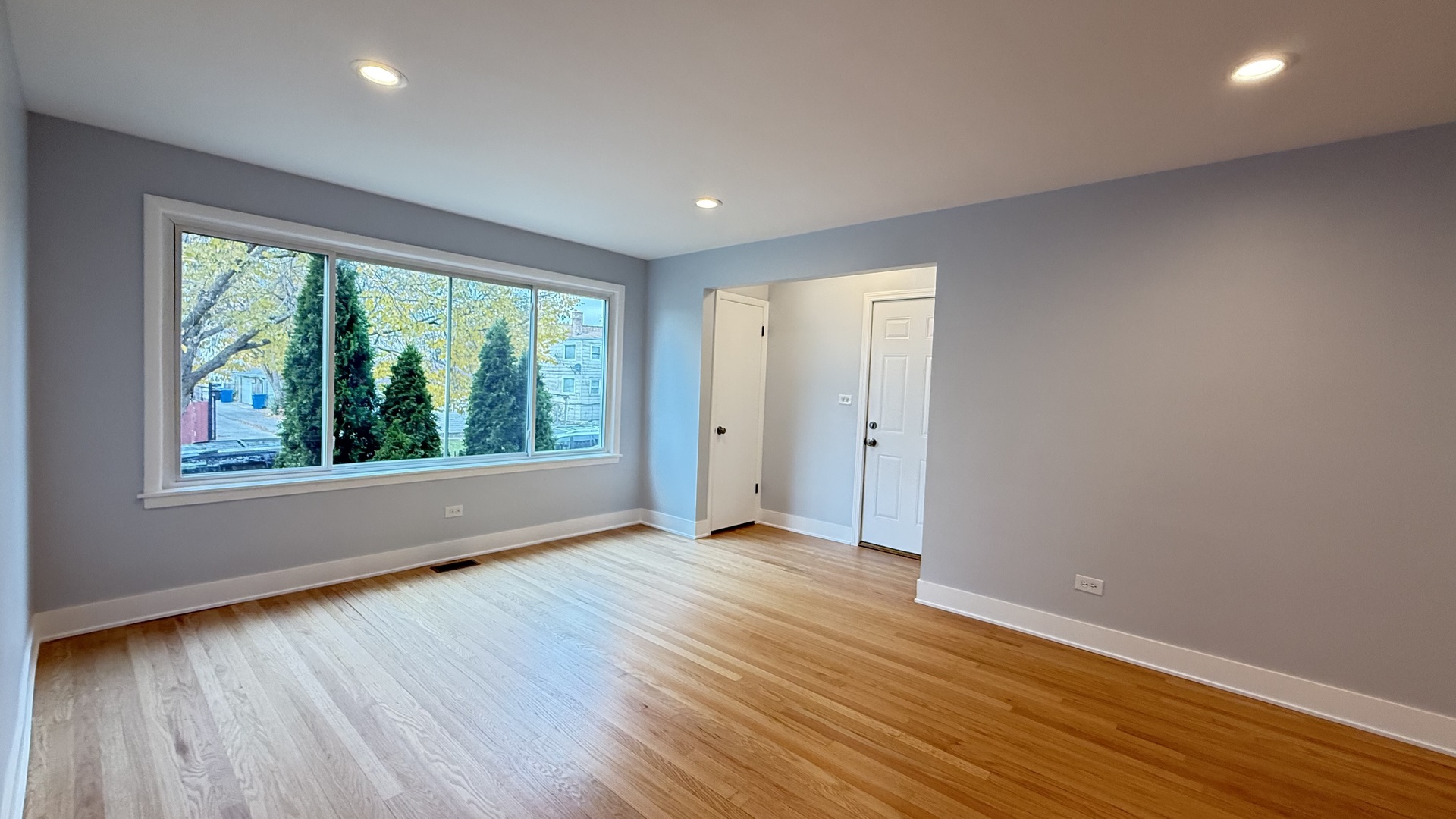 1345 North Latrobe Avenue Chicago, IL 60651 - Photo 24 of 50 a view of an empty room with wooden floor and a window