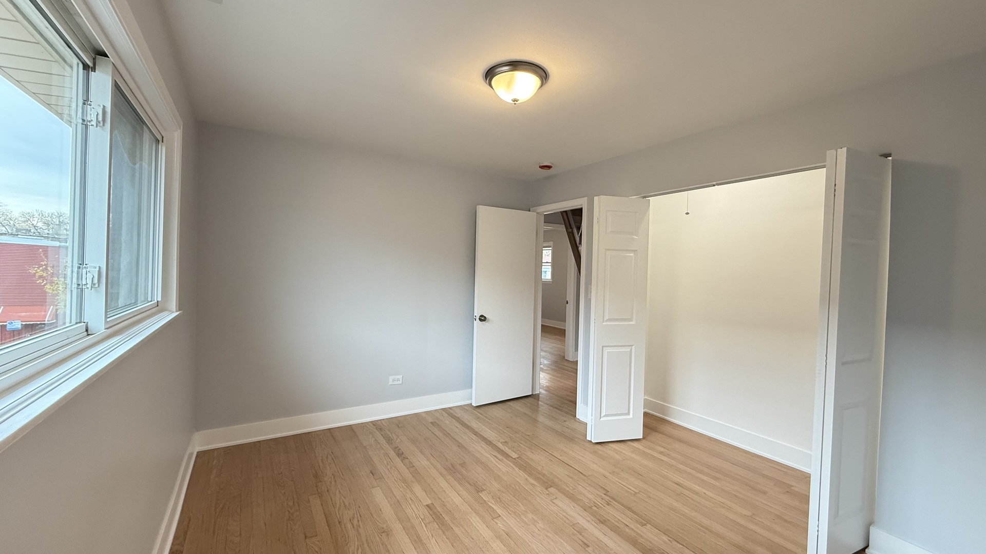 1345 North Latrobe Avenue Chicago, IL 60651 - Photo 28 of 50 a view of an empty room with wooden floor and a window