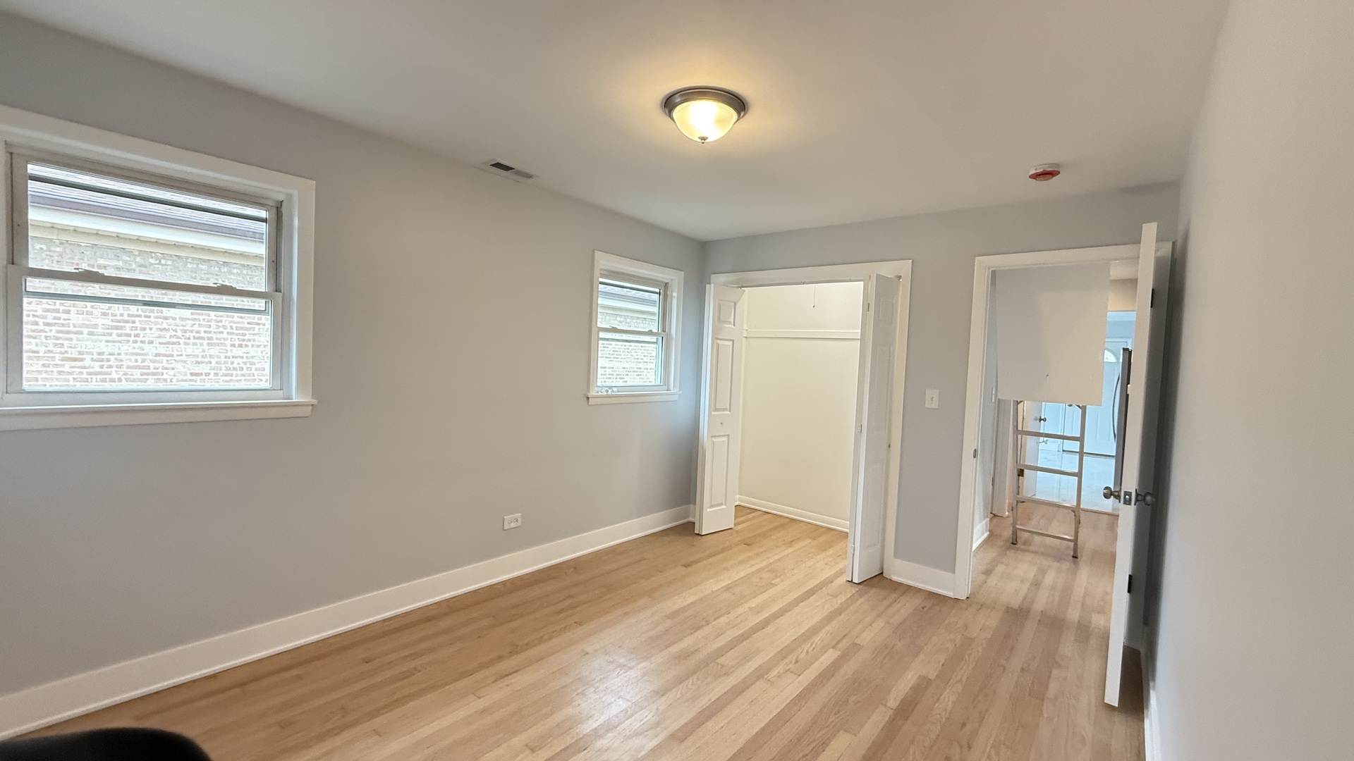 1345 North Latrobe Avenue Chicago, IL 60651 - Photo 30 of 50 a view of an empty room with wooden floor and a window