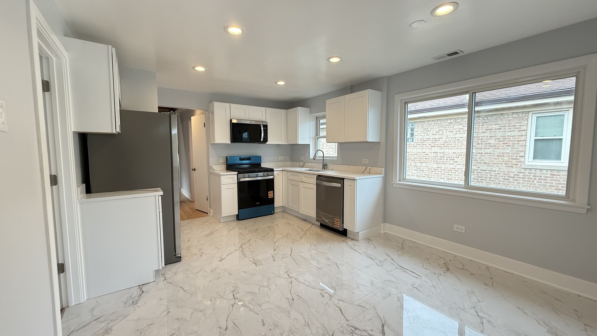 1345 North Latrobe Avenue Chicago, IL 60651 - Photo 36 of 50 a kitchen with stainless steel appliances granite countertop a refrigerator stove microwave and sink
