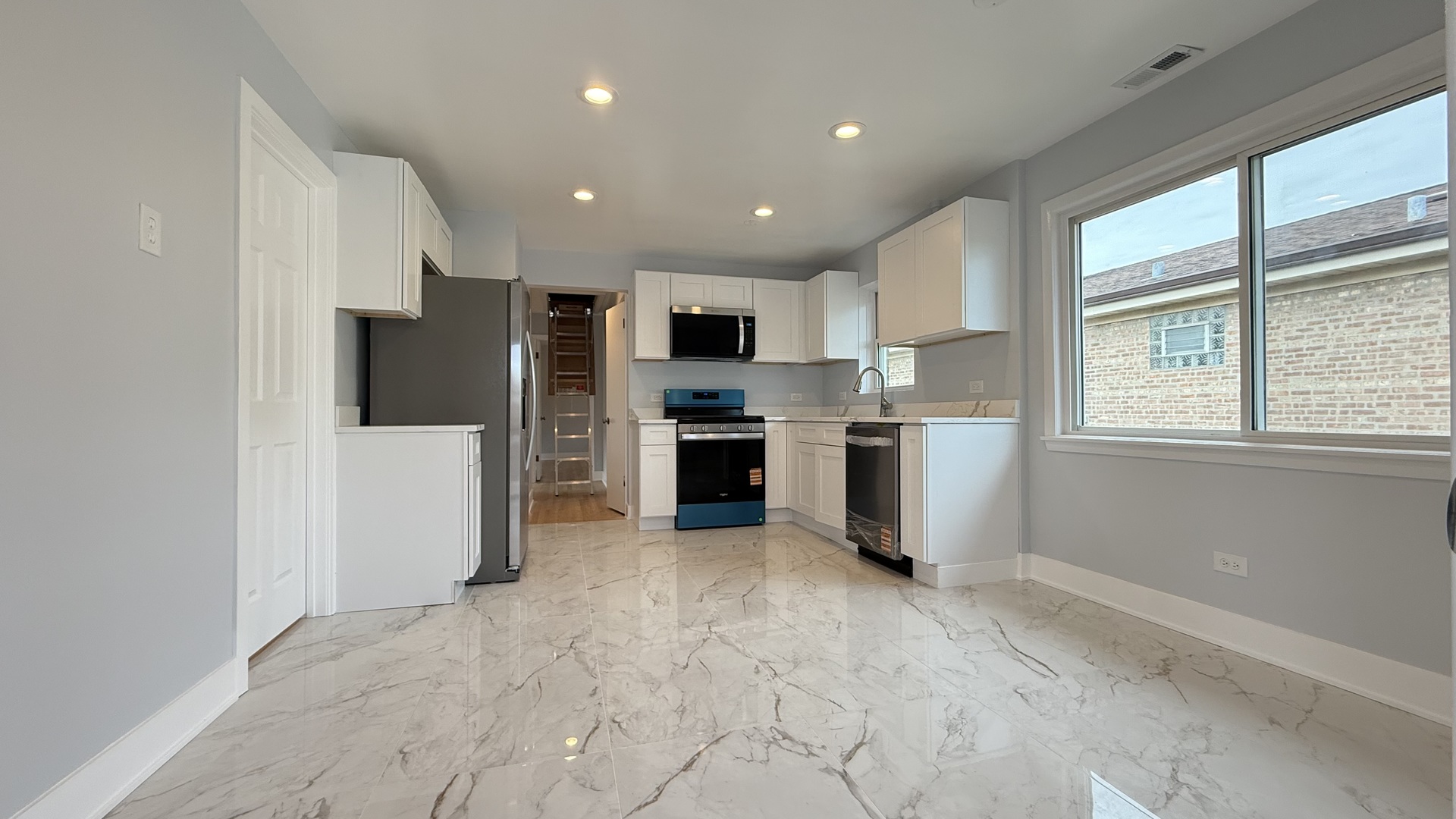1345 North Latrobe Avenue Chicago, IL 60651 - Photo 37 of 50 a view of kitchen with stainless steel appliances kitchen island granite countertop a refrigerator and a stove top oven