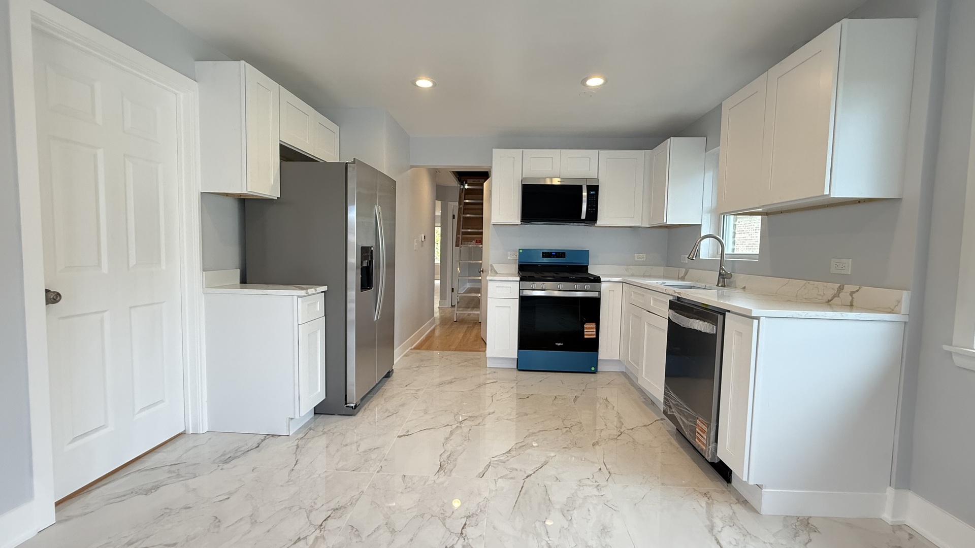 1345 North Latrobe Avenue Chicago, IL 60651 - Photo 38 of 50 a kitchen with stainless steel appliances a refrigerator stove microwave and sink