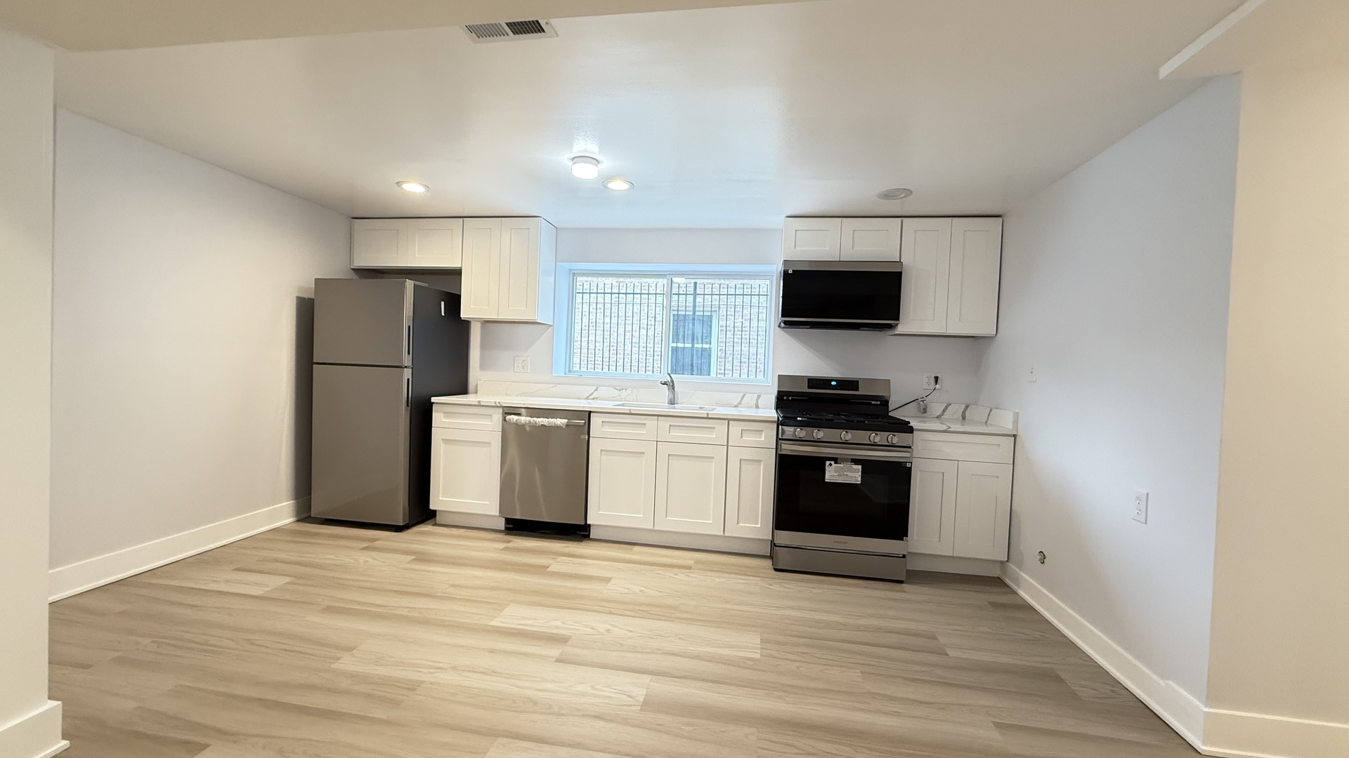 1345 North Latrobe Avenue Chicago, IL 60651 - Photo 44 of 50 a kitchen with a refrigerator and a stove top oven