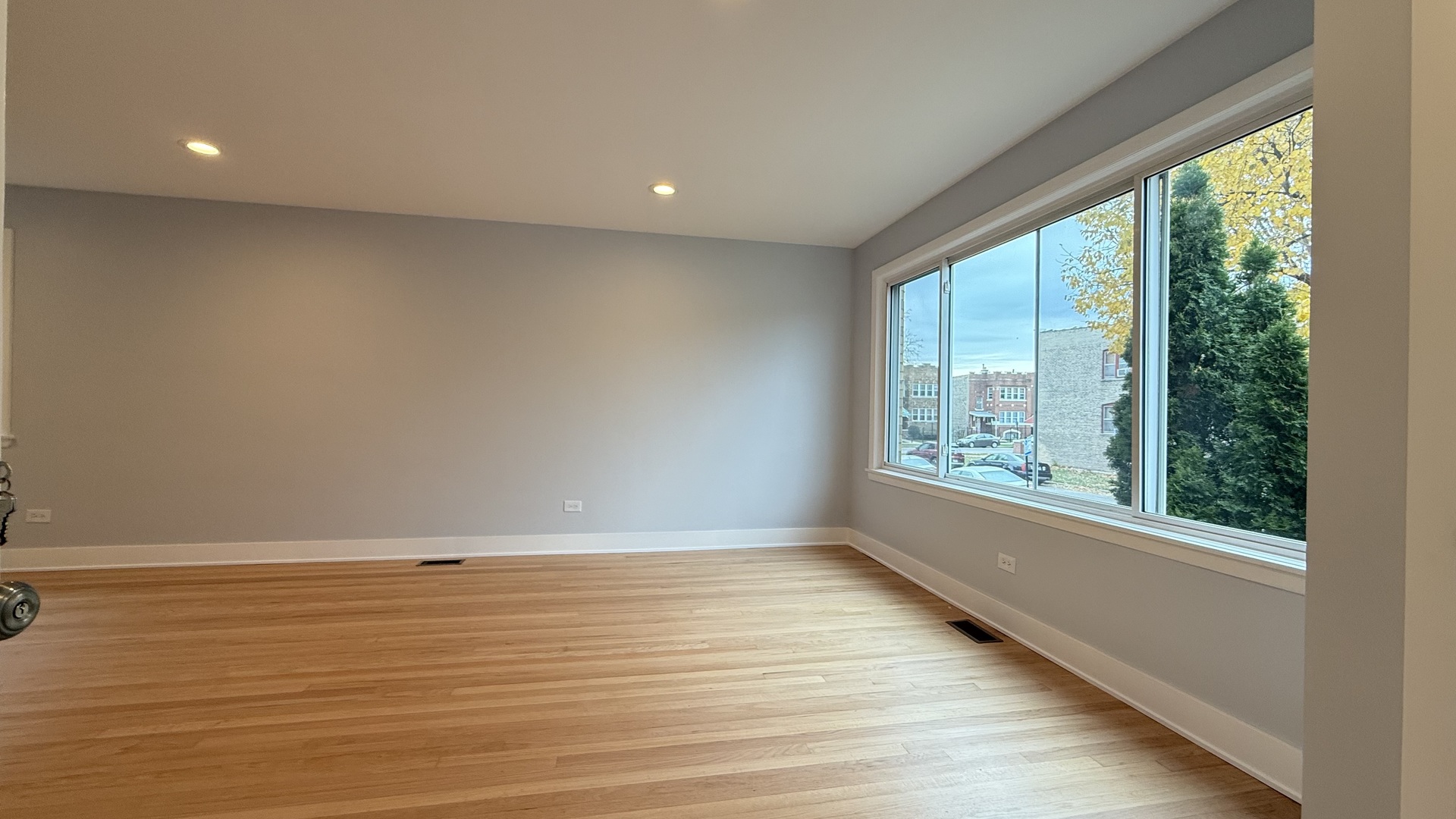 1345 North Latrobe Avenue Chicago, IL 60651 - Photo 5 of 50 an empty room with wooden floor and windows