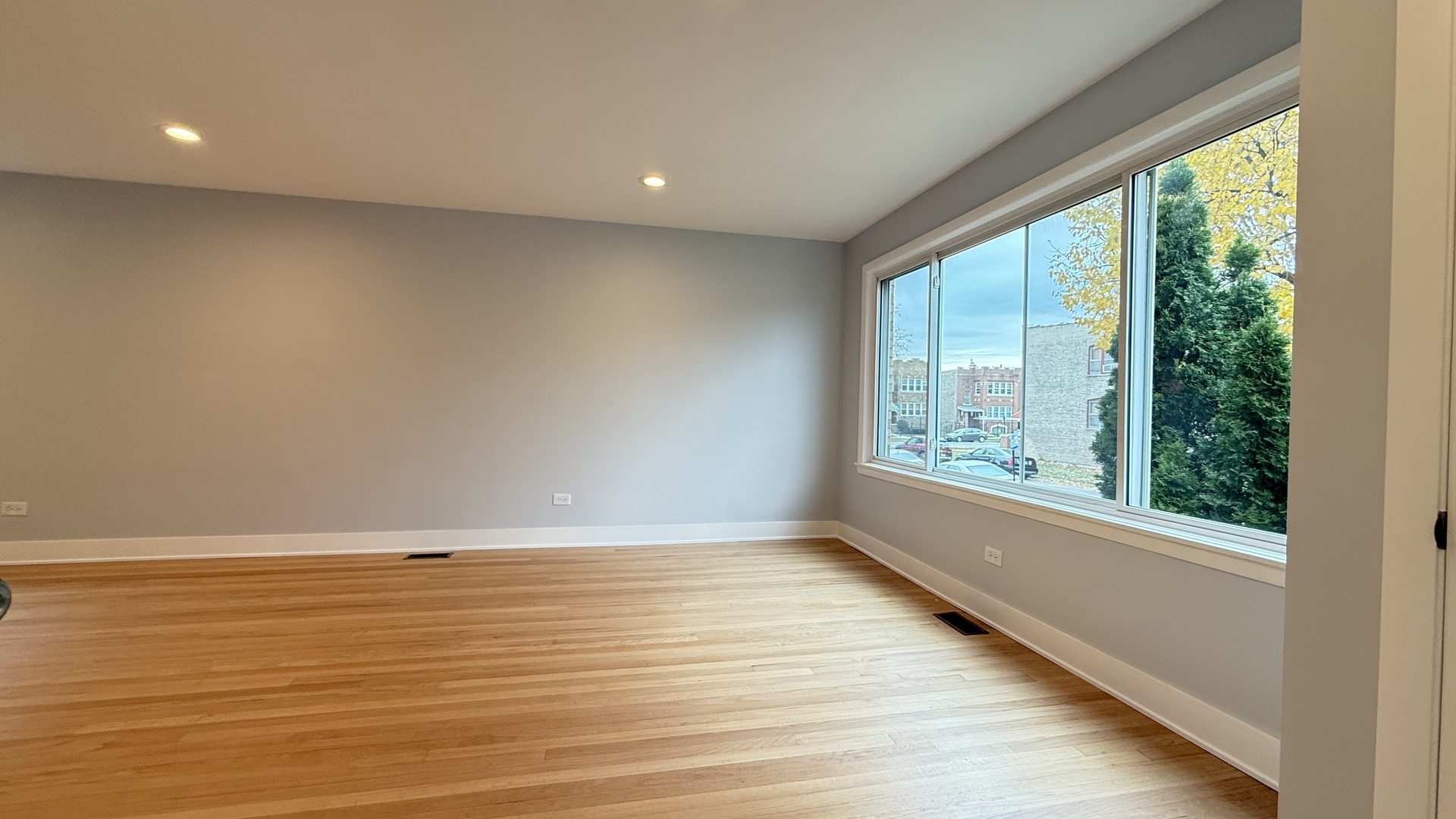 1345 North Latrobe Avenue Chicago, IL 60651 - Photo 6 of 50 a view of an empty room with wooden floor and a window