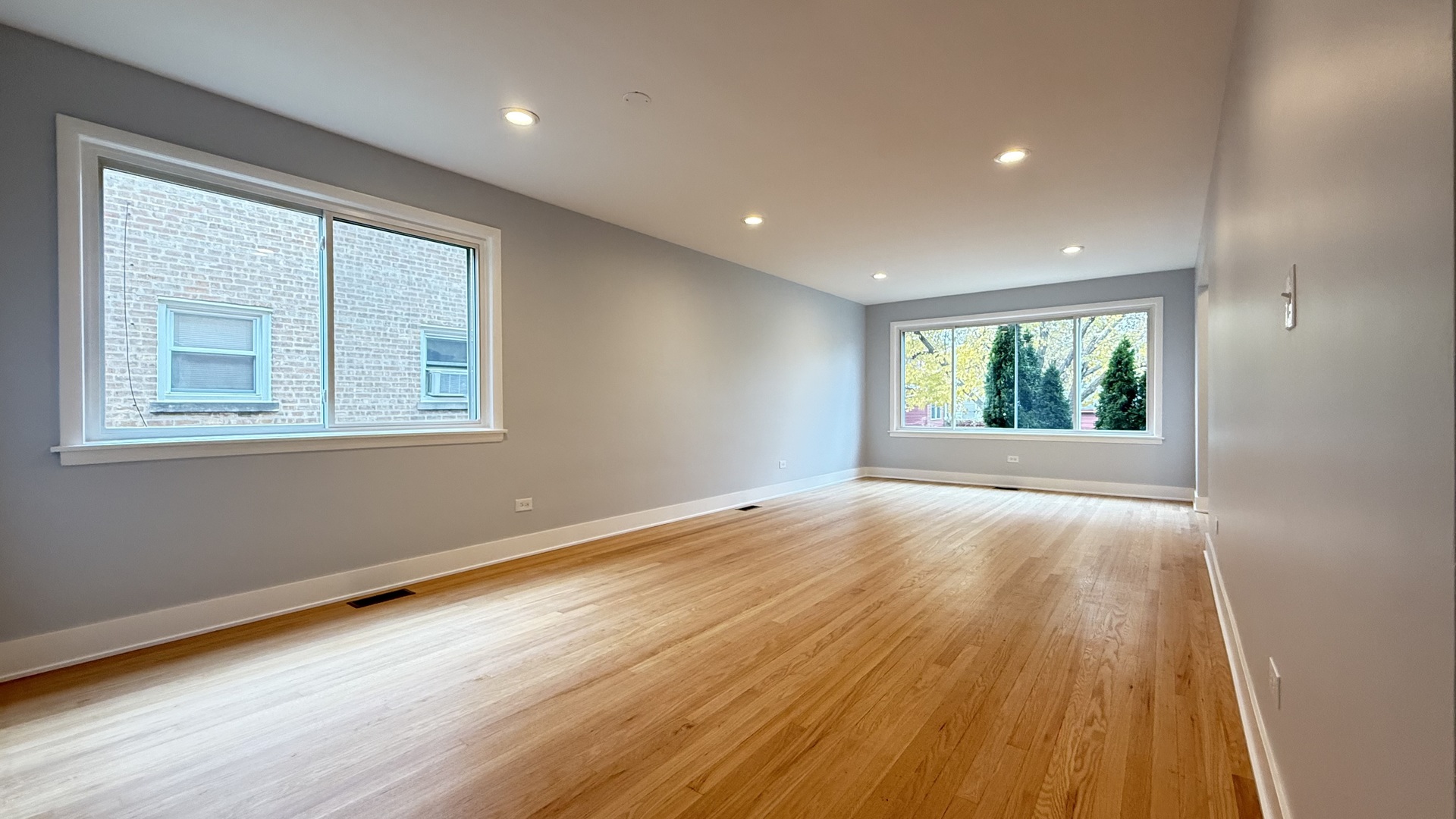 1345 North Latrobe Avenue Chicago, IL 60651 - Photo 8 of 50 a view of an empty room with wooden floor and a window