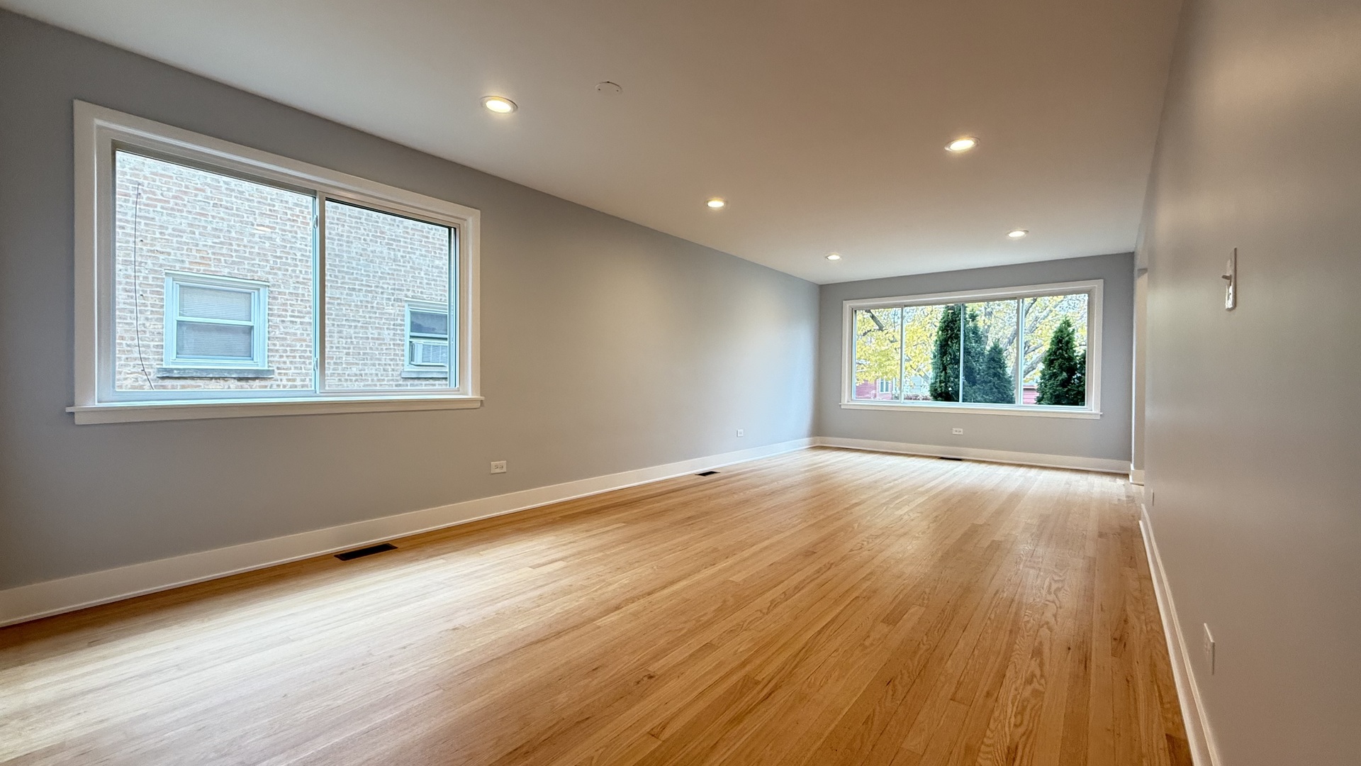 1345 North Latrobe Avenue Chicago, IL 60651 - Photo 9 of 50 a view of an empty room with wooden floor and a window
