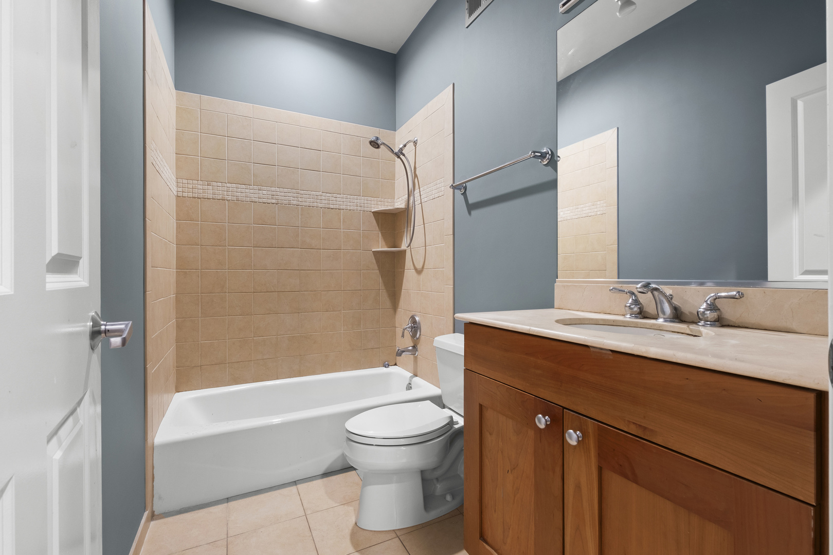 1355 West Washington Boulevard, Unit 4D Chicago, IL 60607 - Photo 24 of 46 a bathroom with a granite countertop sink toilet a mirror and shower