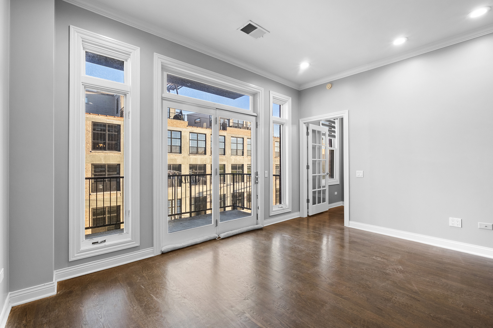 1355 West Washington Boulevard, Unit 4D Chicago, IL 60607 - Photo 10 of 46 a view of an empty room with wooden floor and a window