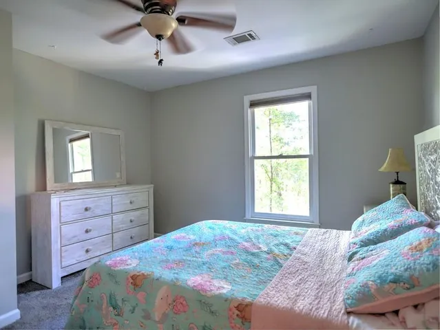 a room with a mirror and fan