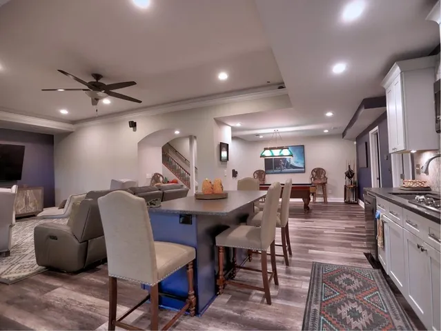 a kitchen with stainless steel appliances granite countertop a sink stove and microwave