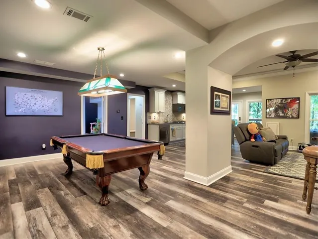 a bathroom with a granite countertop sink a toilet and a mirror