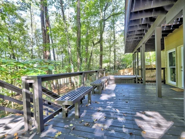 a view of a house with backyard and trees