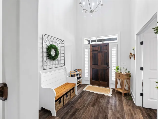 a kitchen with stainless steel appliances kitchen island granite countertop a sink a stove and a wooden floor