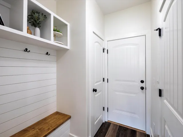 a bedroom with a bed and a painting on the wall