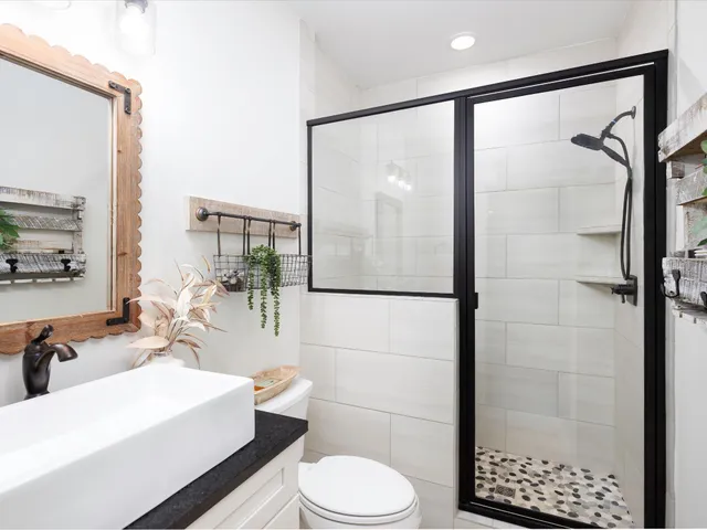 a kitchen with kitchen island a stove a refrigerator a dining table and chairs with wooden floor