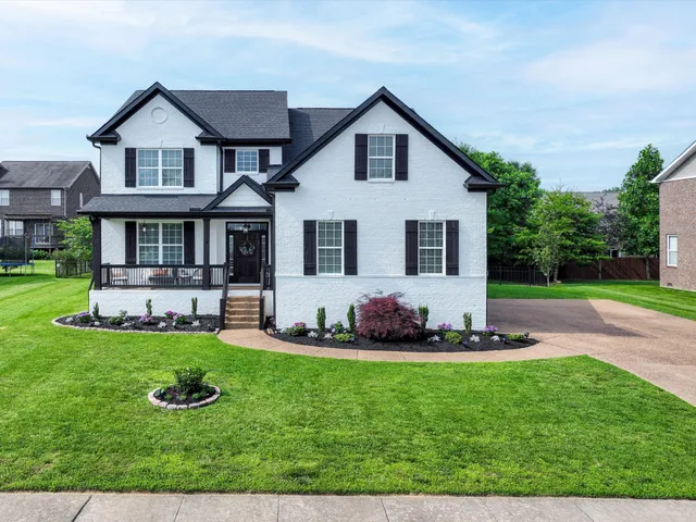 a front view of house with yard and outdoor seating