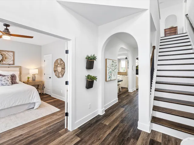 a kitchen with stainless steel appliances granite countertop a sink a stove a refrigerator cabinets and chairs