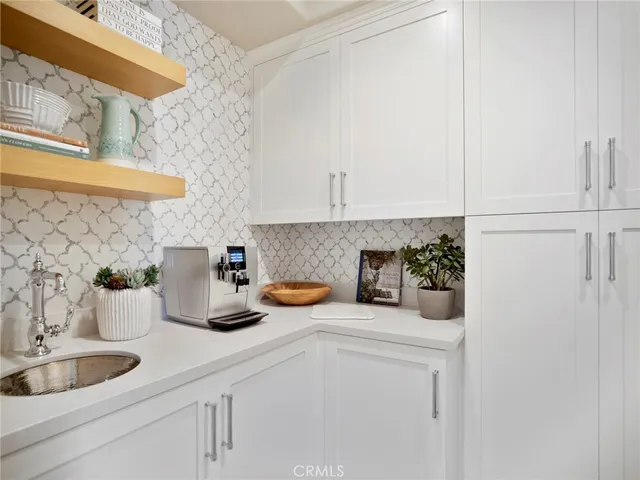 a kitchen with a sink and a white cabinets
