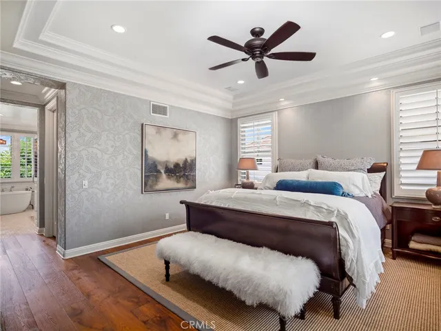 a bedroom with a bed and a painting on the wall