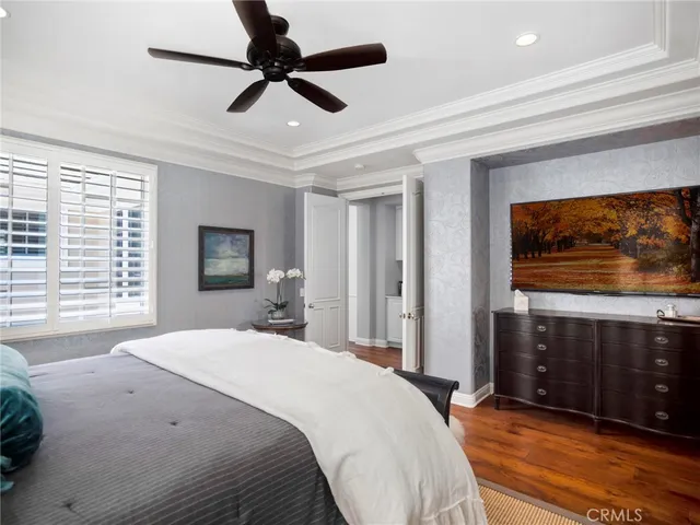 a bedroom with a bed and a dresser next to a window