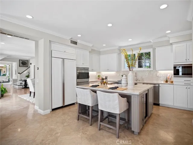 a kitchen with a sink a table and chairs