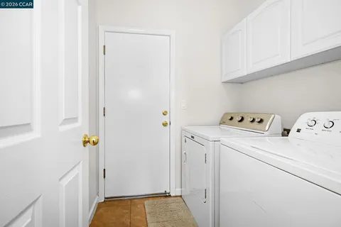 a view of storage and utility room with washer and dryer