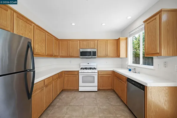 a kitchen with a sink a refrigerator and window