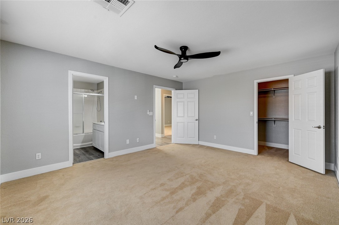 7259 Cestrum Road Las Vegas, NV 89113 - Photo 16 of 35 A spacious sleeping area features soft carpeting and direct access to an adjacent bath and closet.