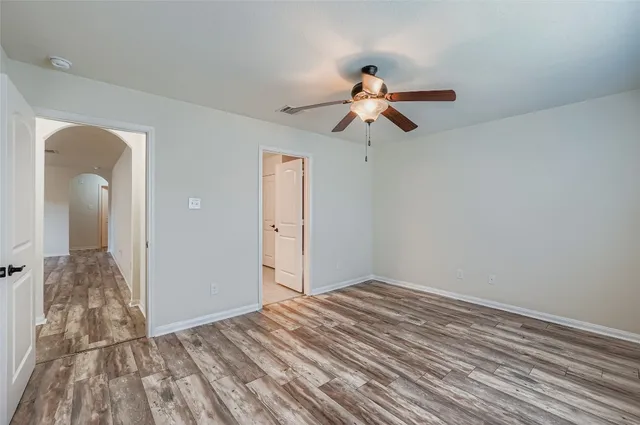 a view of a room with wooden floor