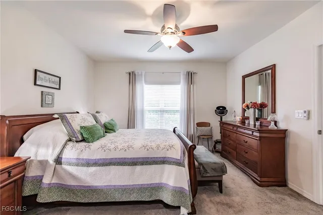 a bedroom with a bed and a dresser with mirror