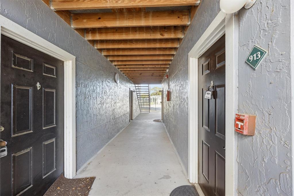 3705 Southwest 27th Street, Unit 913 Gainesville, FL 32608 - Photo 12 of 50 a view of a porch with wooden floor and stairs