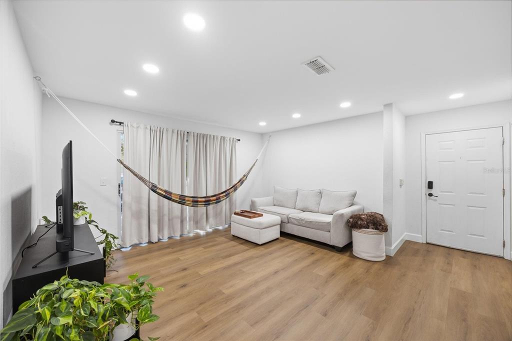 3705 Southwest 27th Street, Unit 913 Gainesville, FL 32608 - Photo 13 of 50 a living room with furniture a window and gym equipment