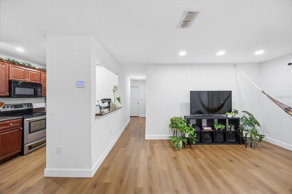 3705 Southwest 27th Street, Unit 913 Gainesville, FL 32608 - Photo 14 of 50 a living room with stainless steel appliances furniture and wooden floor