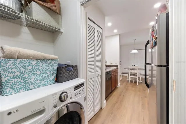 a view of washer and dryer with kitchen in the background