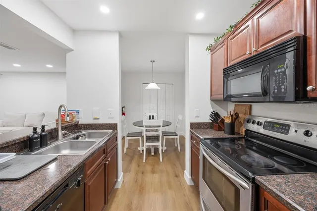 a kitchen with stainless steel appliances granite countertop a sink stove and microwave