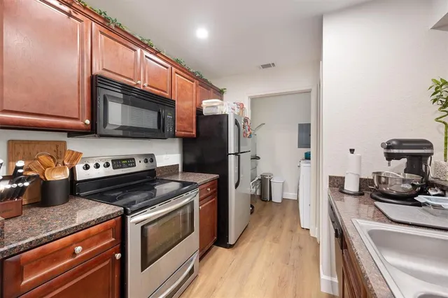 a kitchen with a stove microwave and refrigerator