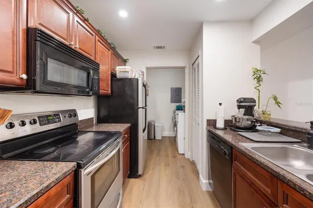 a kitchen with a stove sink and refrigerator