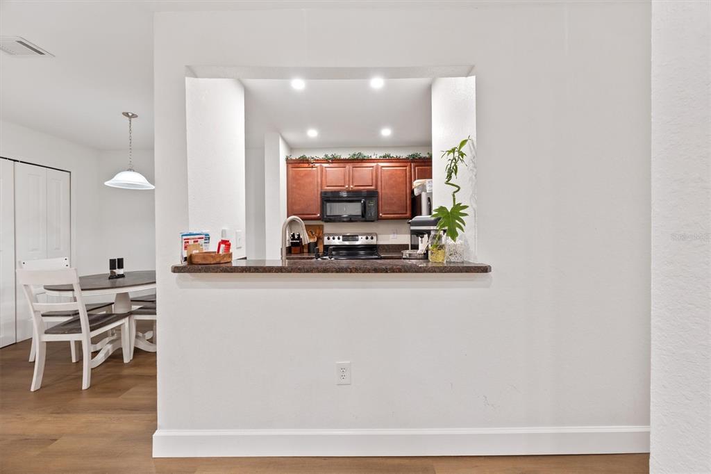 3705 Southwest 27th Street, Unit 913 Gainesville, FL 32608 - Photo 25 of 50 a view of a kitchen with kitchen island stainless steel appliances a dining table and chairs